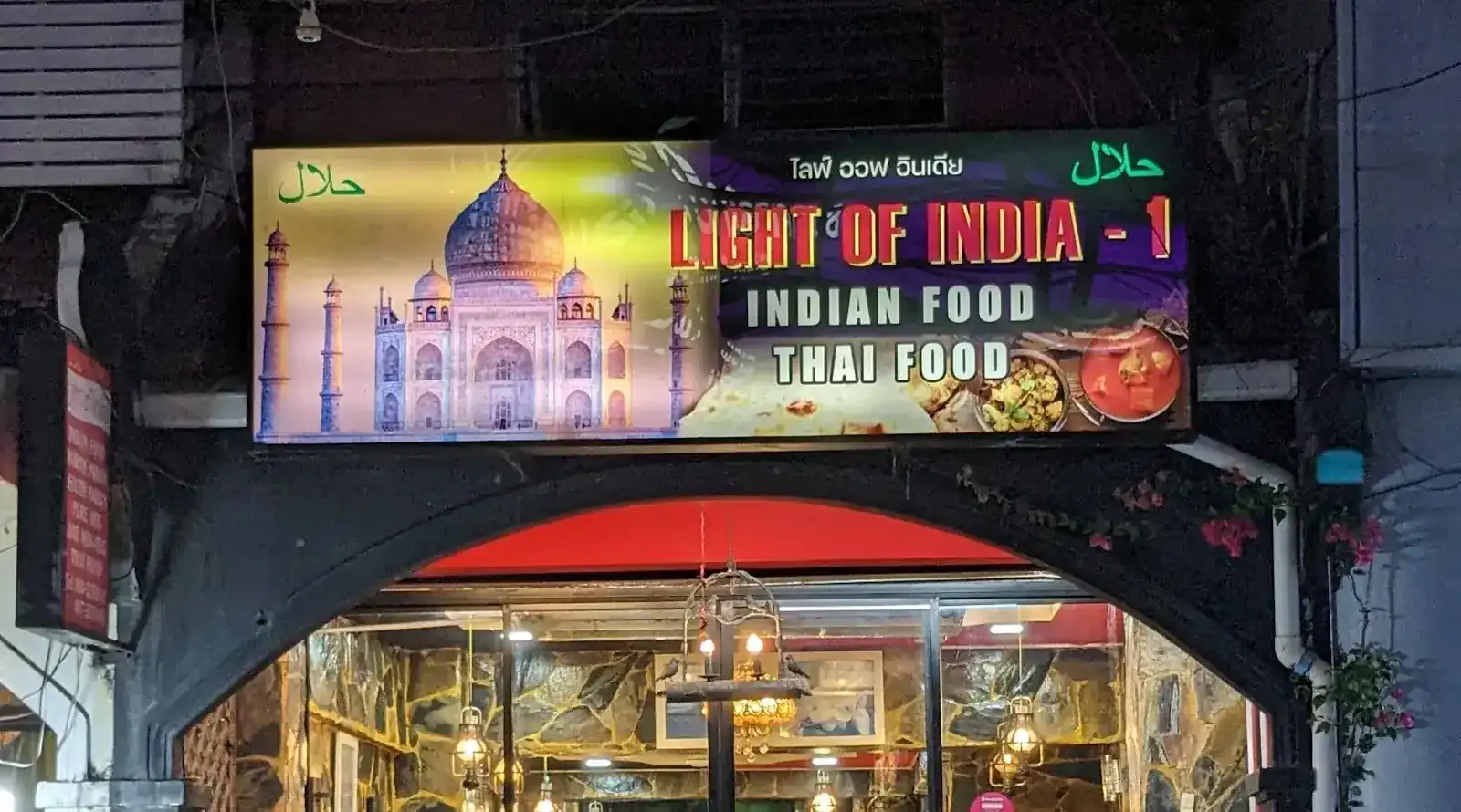 The lit sign over the door at night: Light of India - 1, Indian food, Thai food