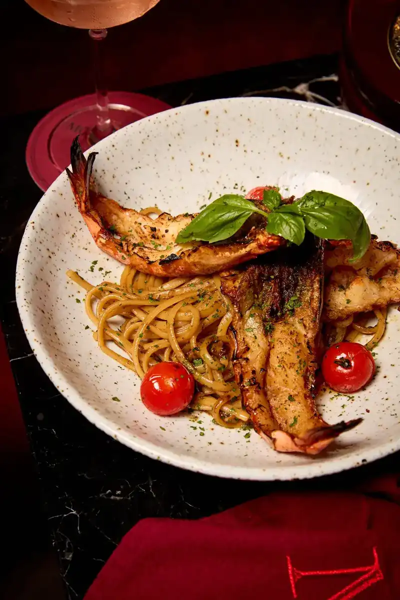 House-made pasta with grilled prawns, cherry tomatoes and basil