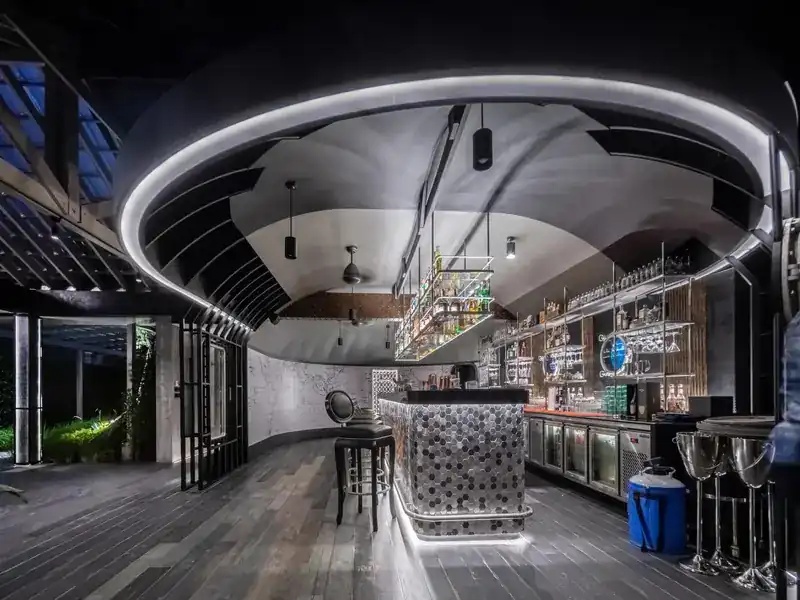 The bar at night under its curved, hull-shaped ceiling