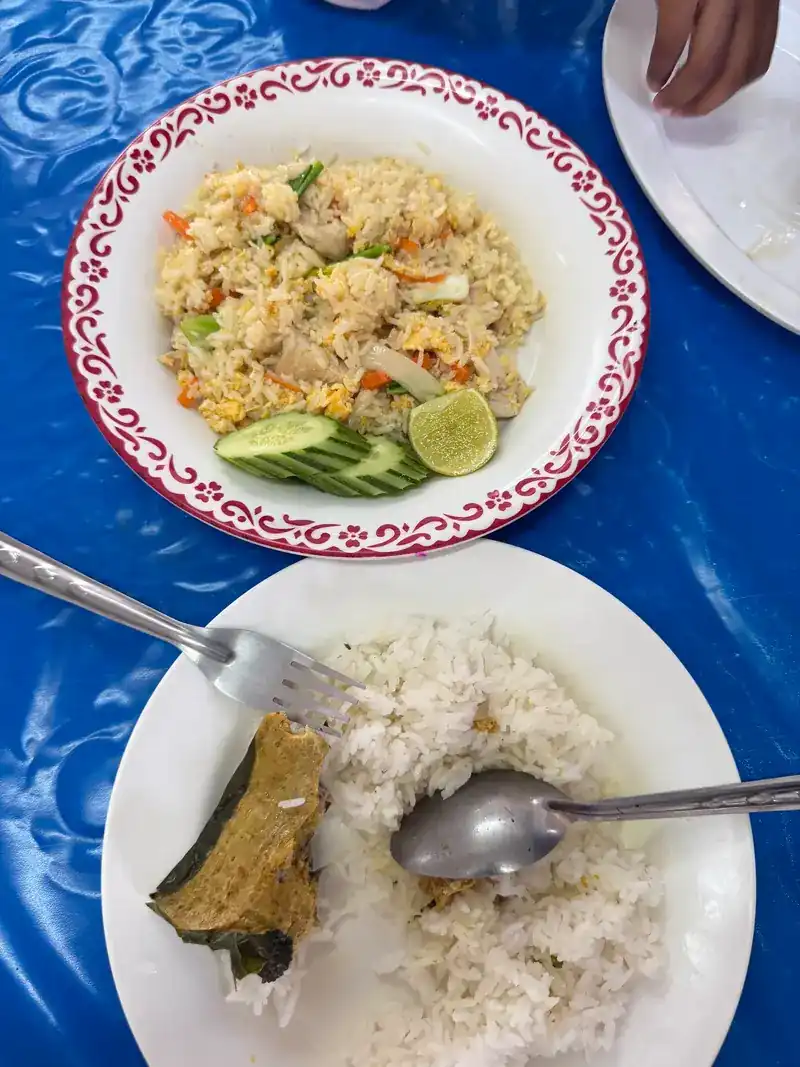Fried rice with lime and cucumber, and a plate of rice beside it