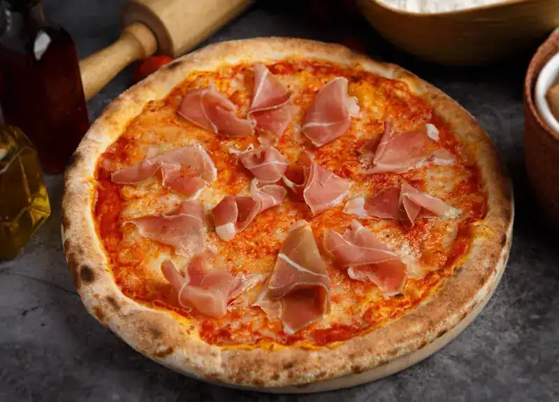 Wood-fired pizza topped with Parma ham