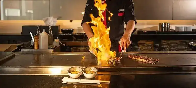 Flames leaping from the teppan as the chef cooks