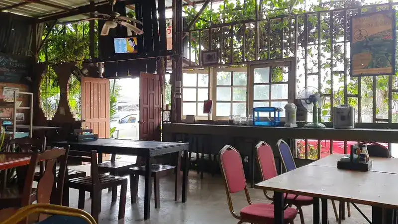Tables by the open windows, with plants outside