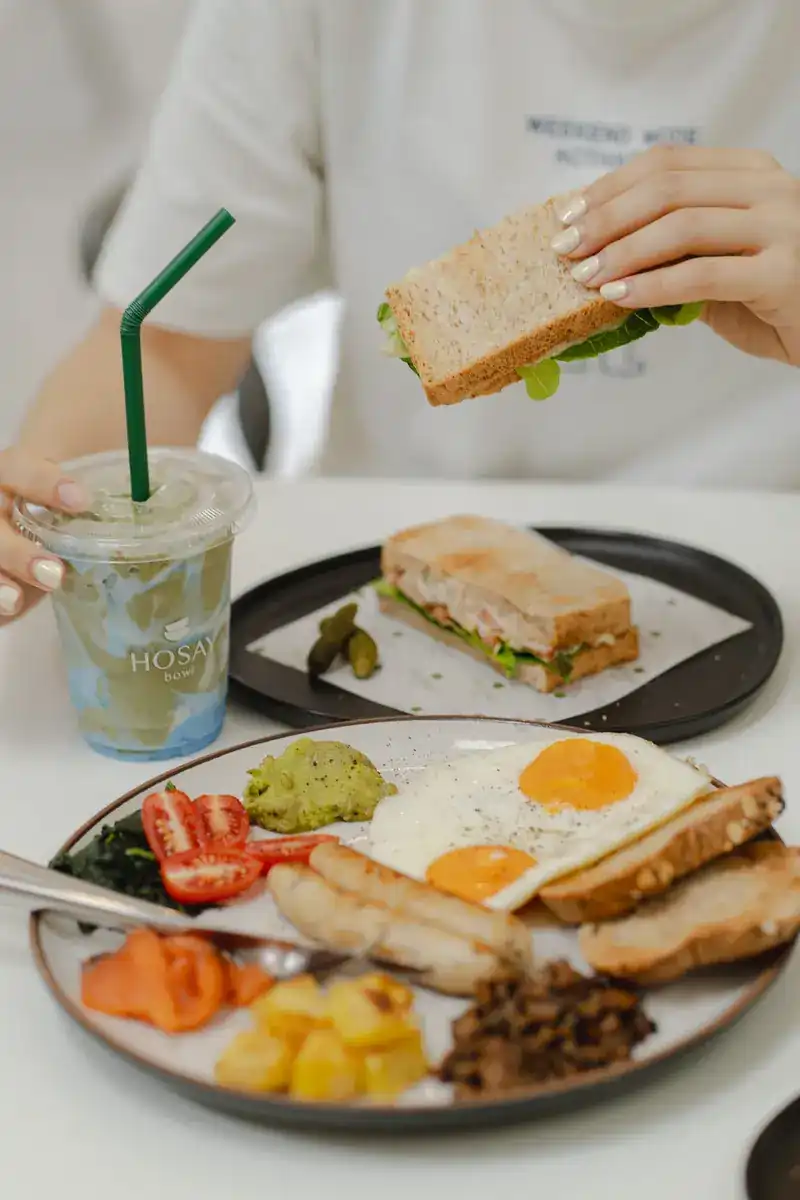A breakfast plate with eggs and a toasted sandwich