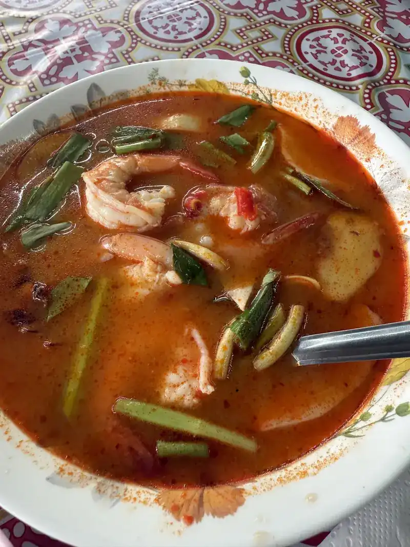Spicy red soup with prawns, lemongrass and herbs