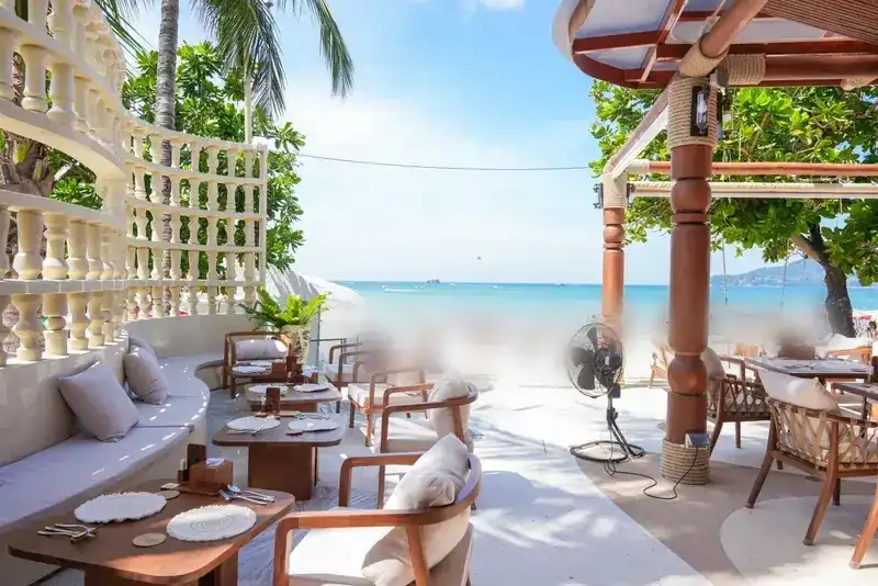 The terrace by day, with white balustrades on one side and Patong Beach straight ahead