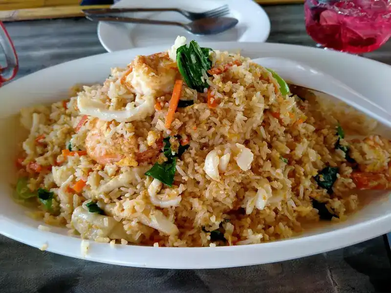 Seafood fried rice with squid, prawn, carrot and greens