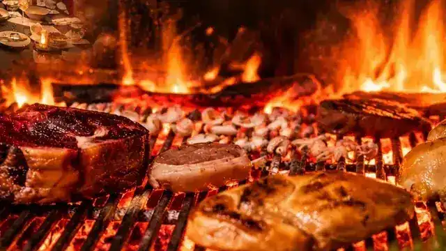 Meat, chicken and mushrooms over the flames of the woodfire grill