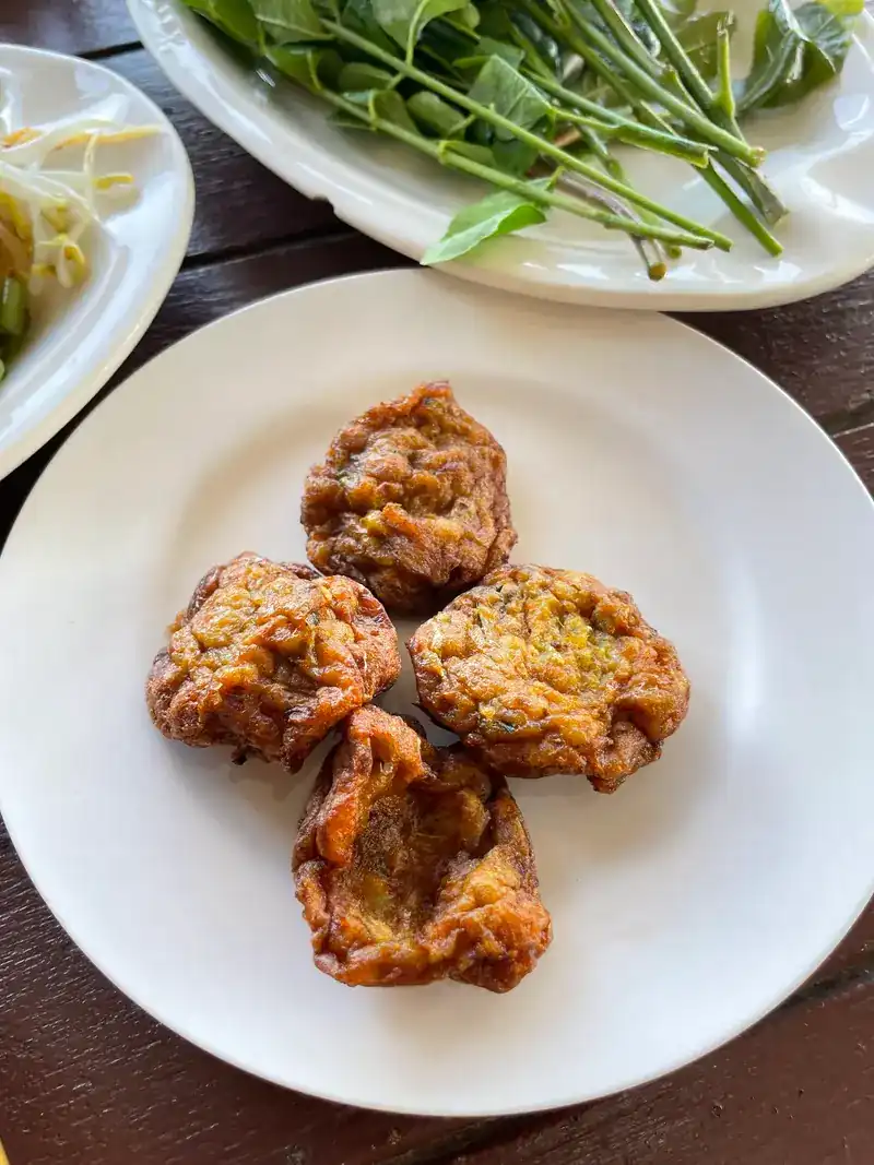 Fried fish cakes on a white plate