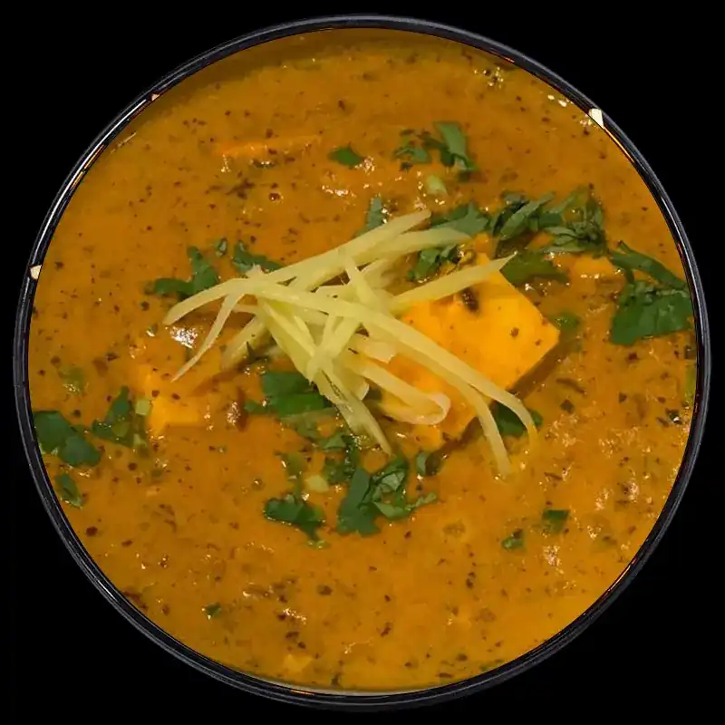 Paneer in gravy topped with shredded ginger