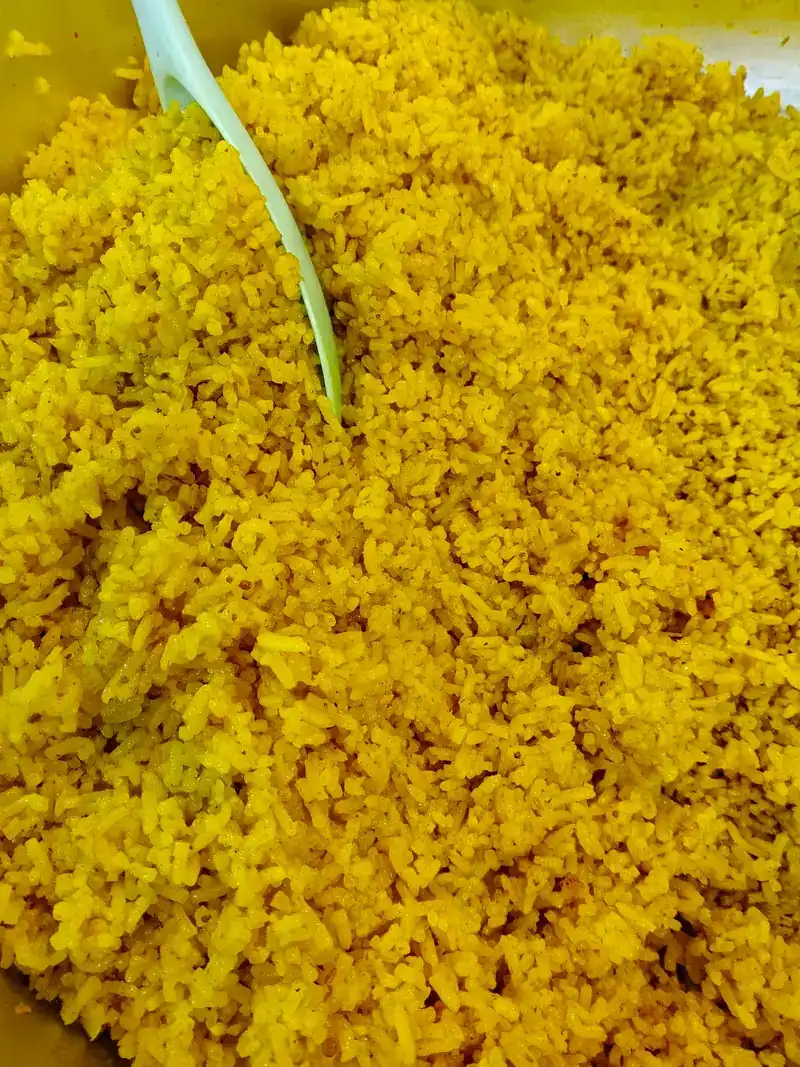 A tray of bright yellow khao mok rice