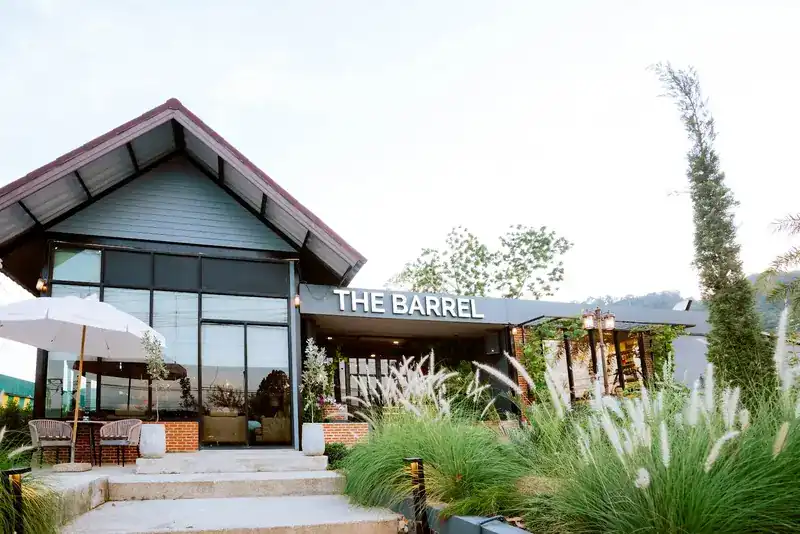 The Barrel in Cherngtalay: a gabled house with a terrace, steps and a garden