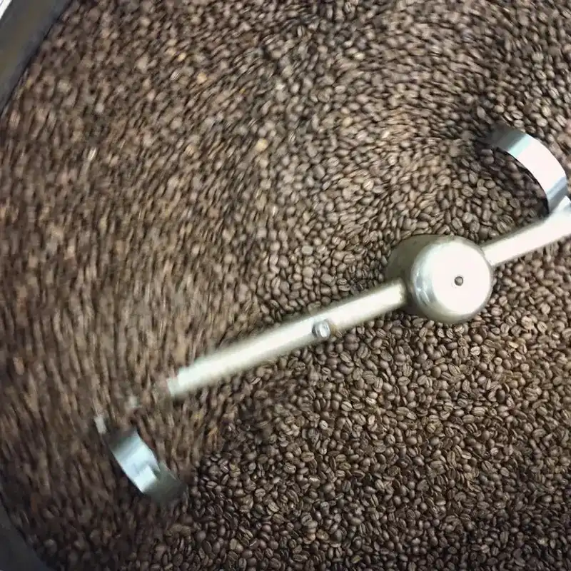 Coffee beans turning in the roaster's cooling tray