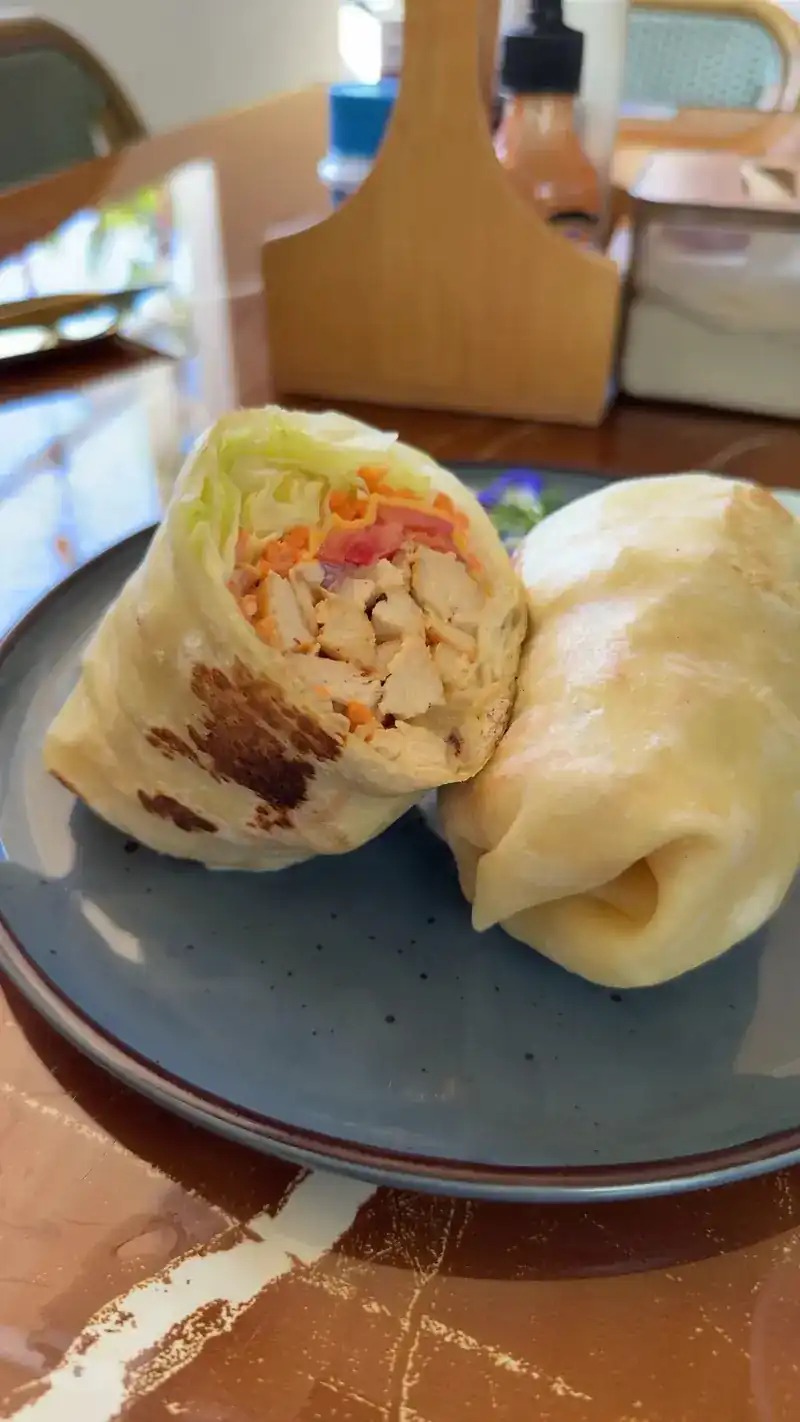 A chicken and vegetable wrap cut in half