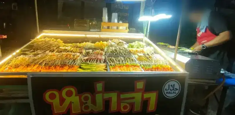 The mala cart at night, its case lit up and the Halal badge on the front