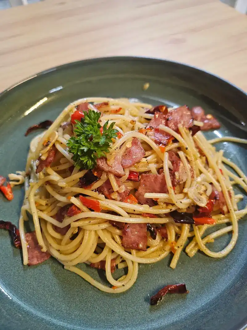 Spaghetti tossed with dried chillies, topped with parsley