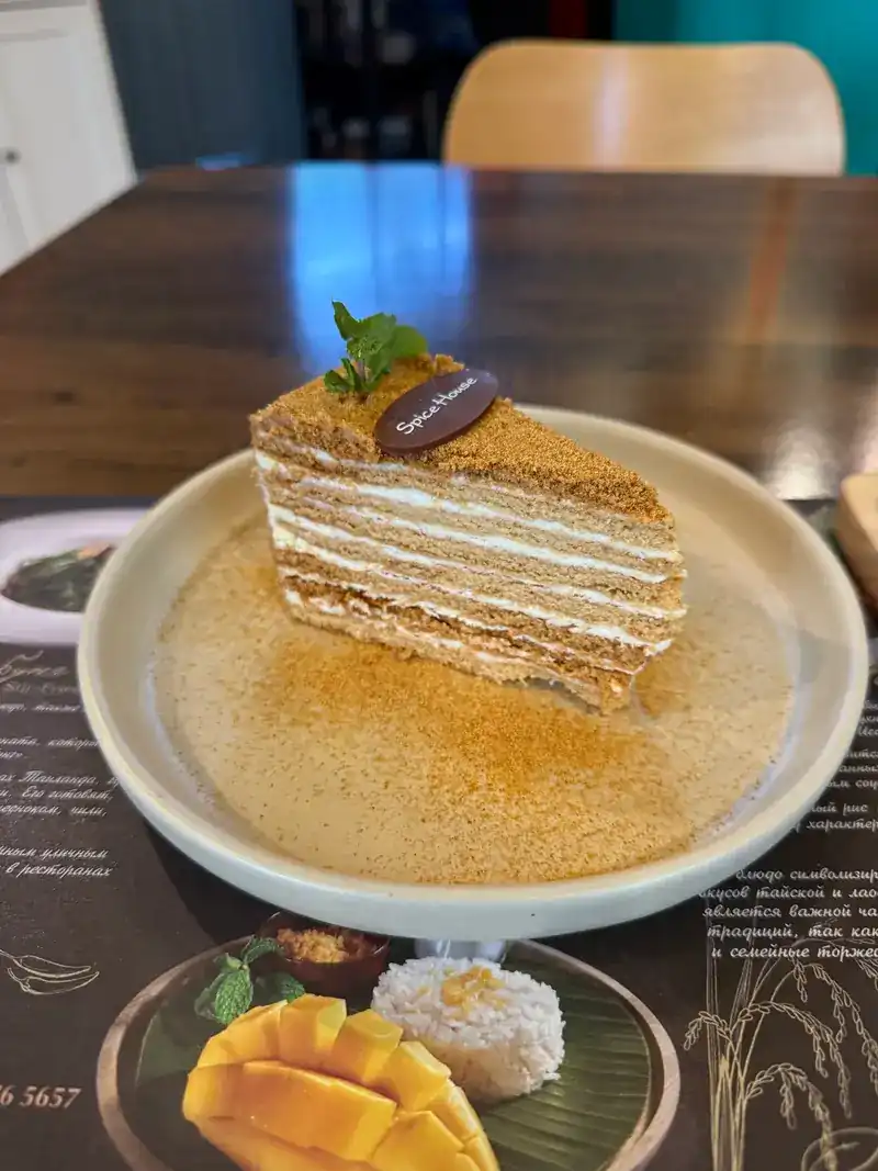 A slice of medovik honey cake with a Spice House chocolate tag