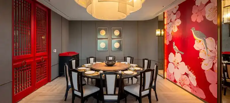 A smaller private room with a red lattice door and a blossom mural