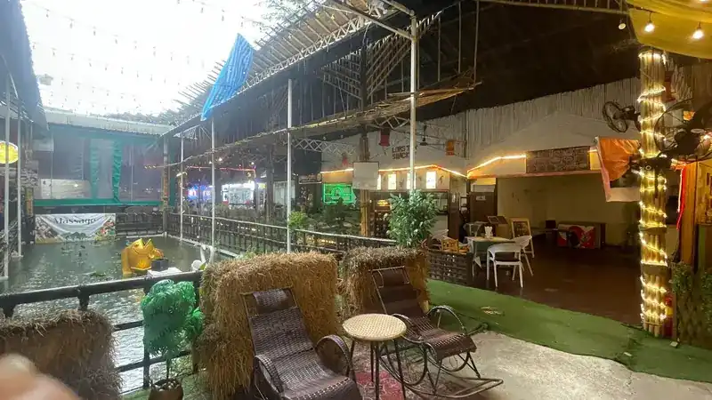 Rocking chairs and straw bales beside the water at Layna Plaza
