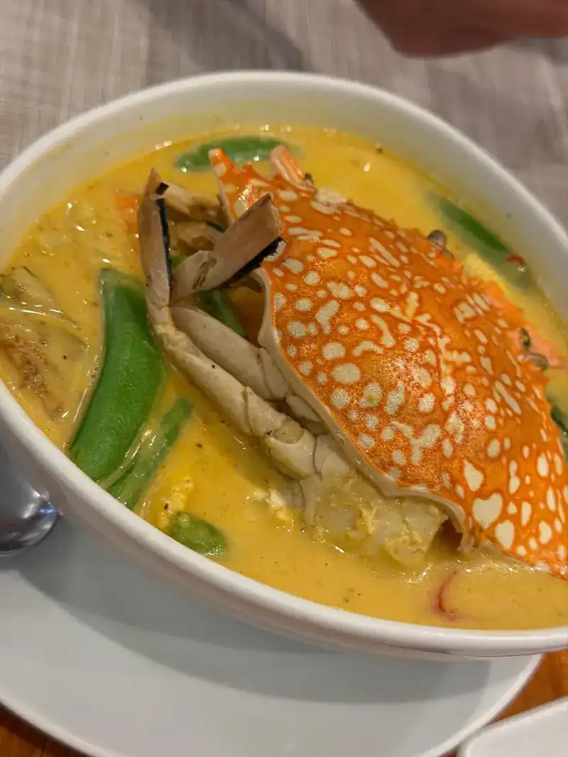 Crab in a yellow coconut curry with snow peas