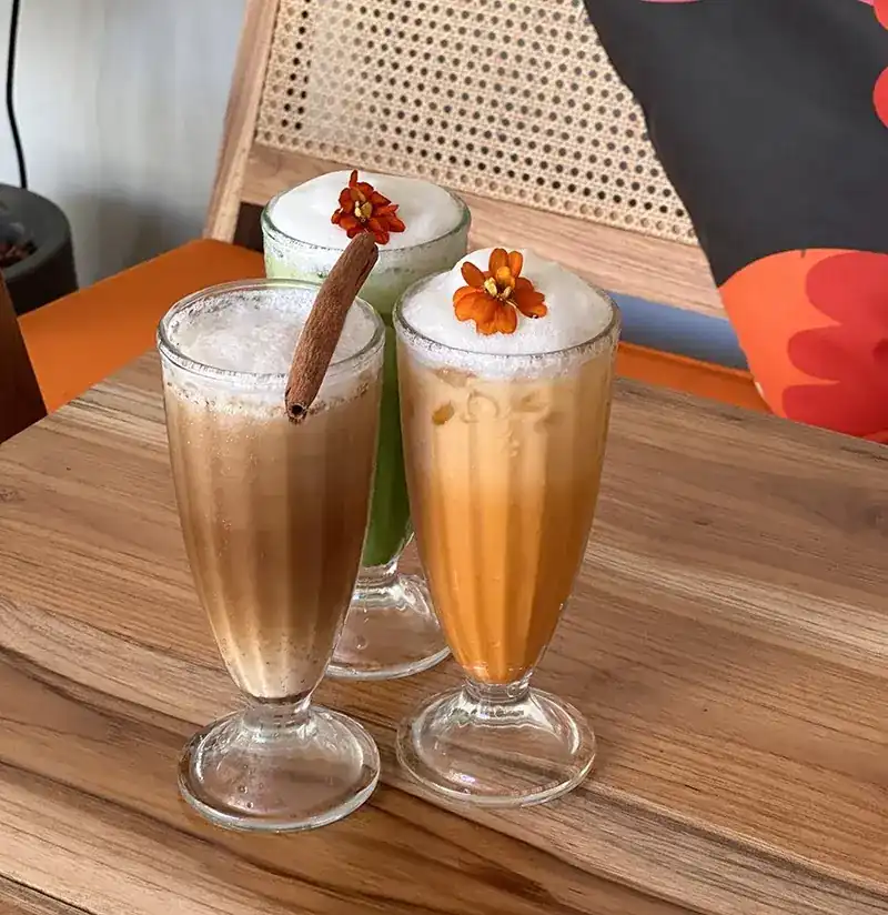 Iced coffee and Thai tea topped with orange flowers