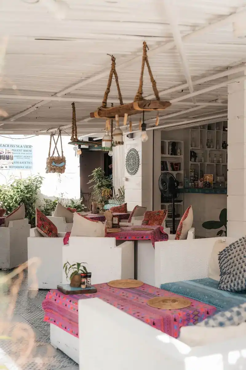 White sofas, bright woven table cloths and driftwood lamps in the open-air room