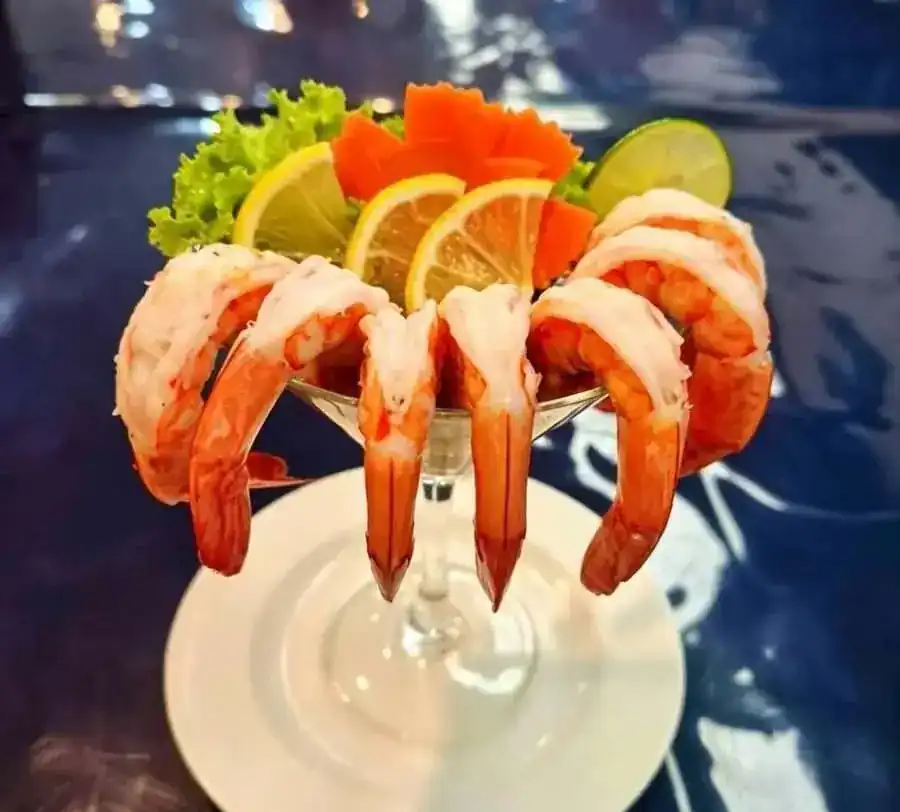 Shrimp cocktail with lemon and lime slices