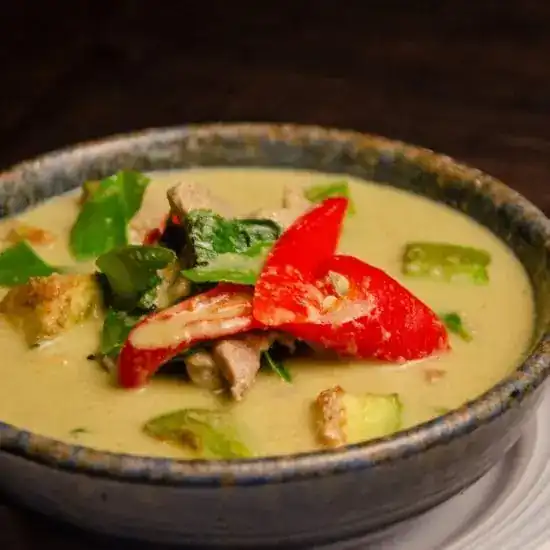 Green curry in a stoneware bowl