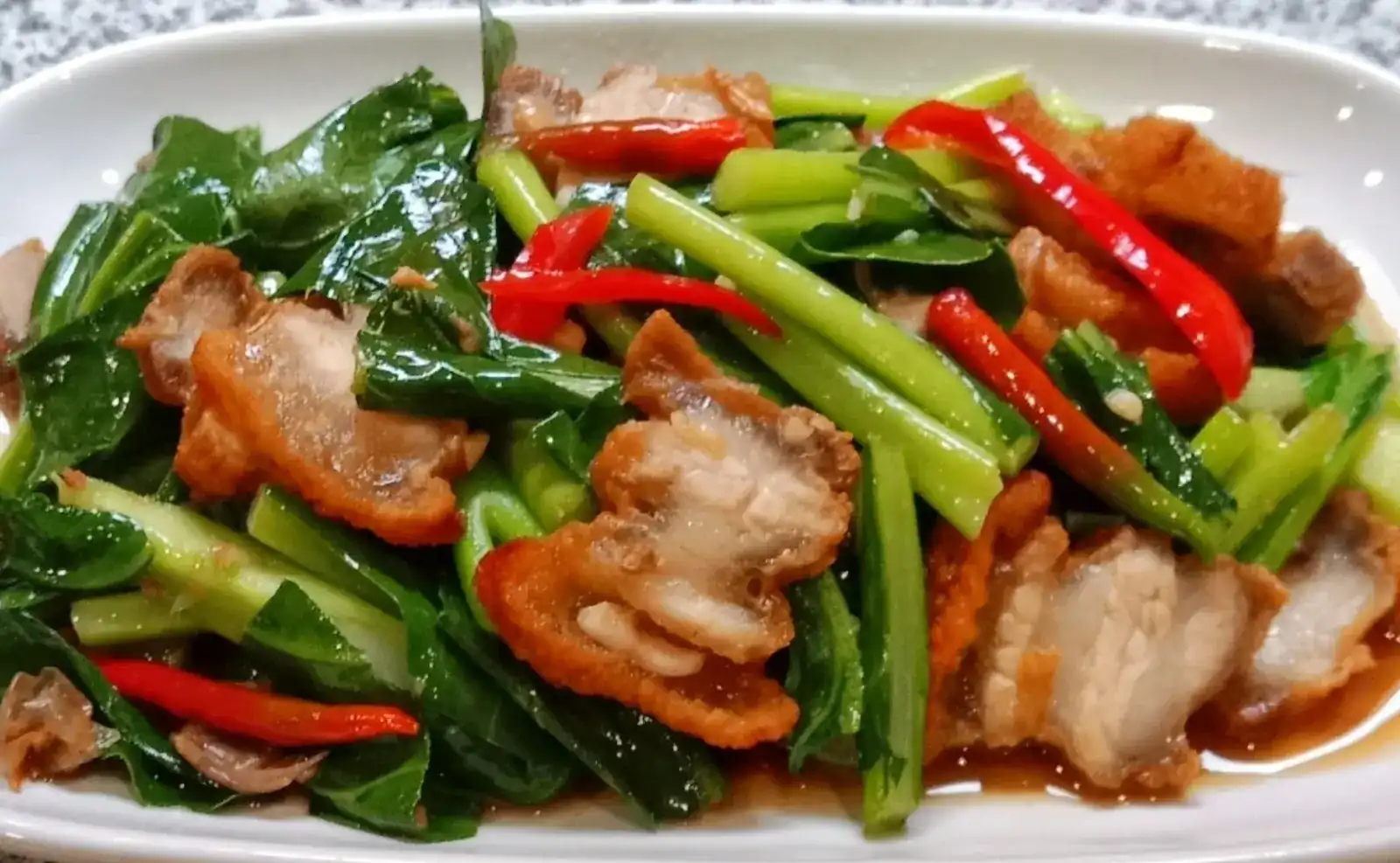 Chinese kale stir-fried with crispy pork and red chilli