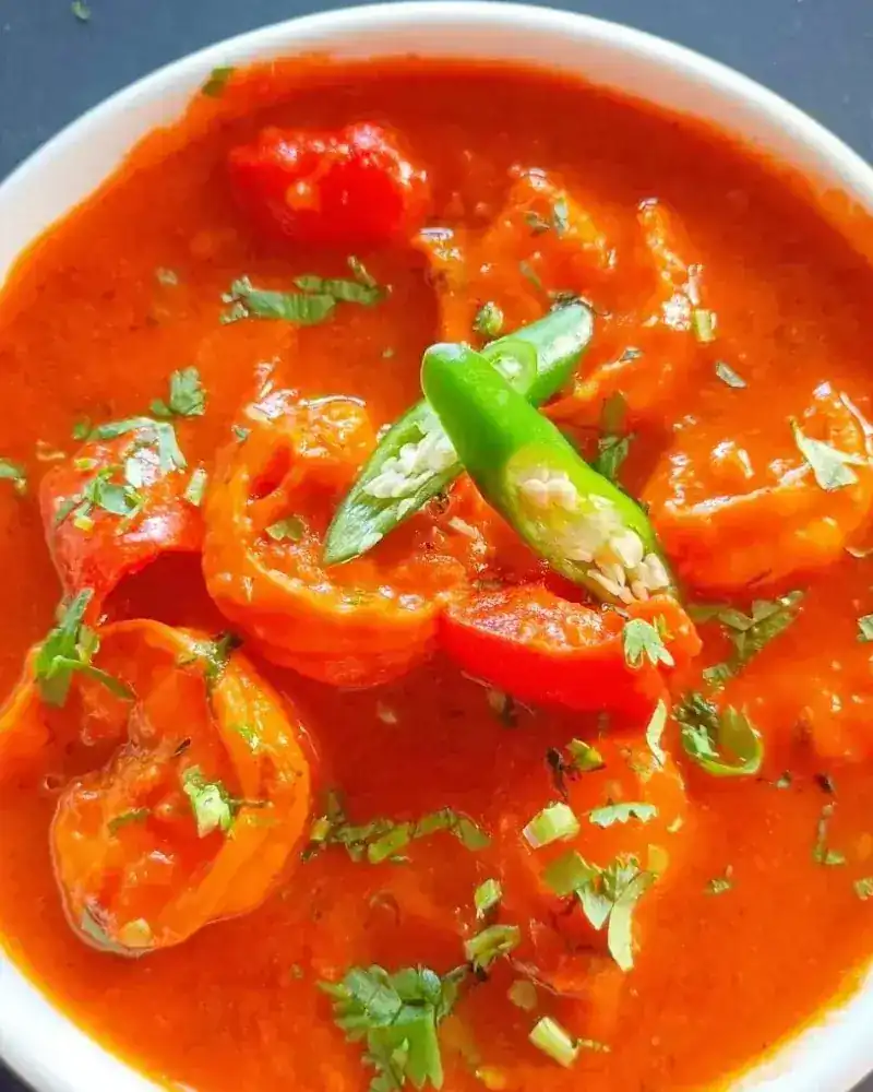 Prawns in a red curry with sliced green chilli