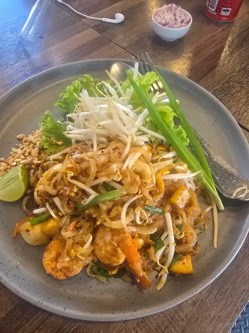 Pad Thai with prawns, bean sprouts, crushed peanuts, spring onion and lime