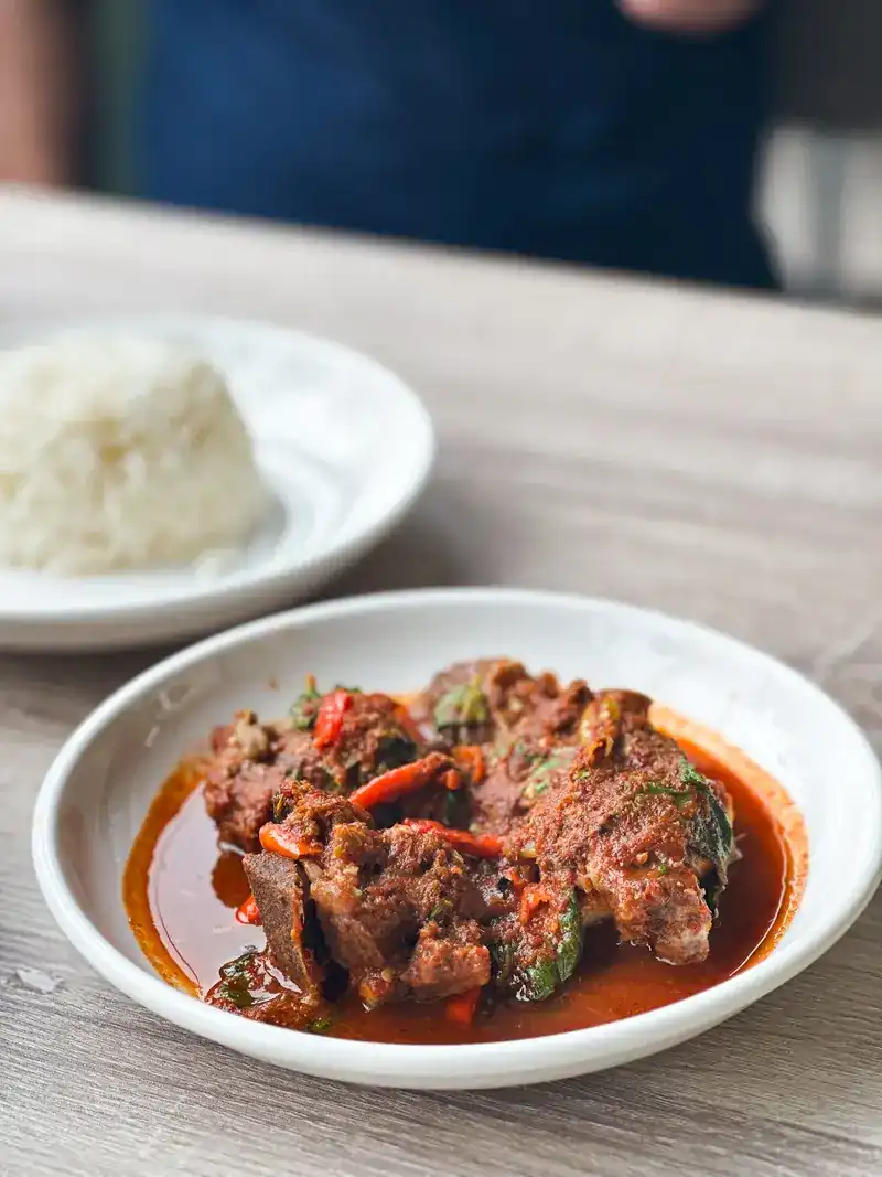 Braised beef in a red chilli sauce, with a plate of rice