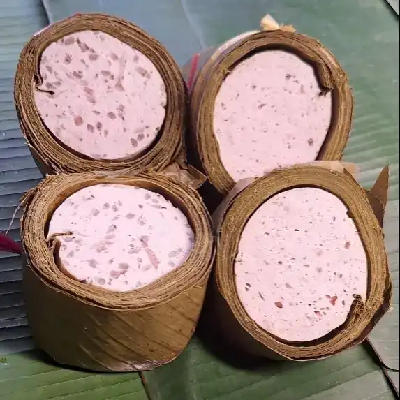 Pork rolls in dried banana-leaf wrappers, cut to show the inside