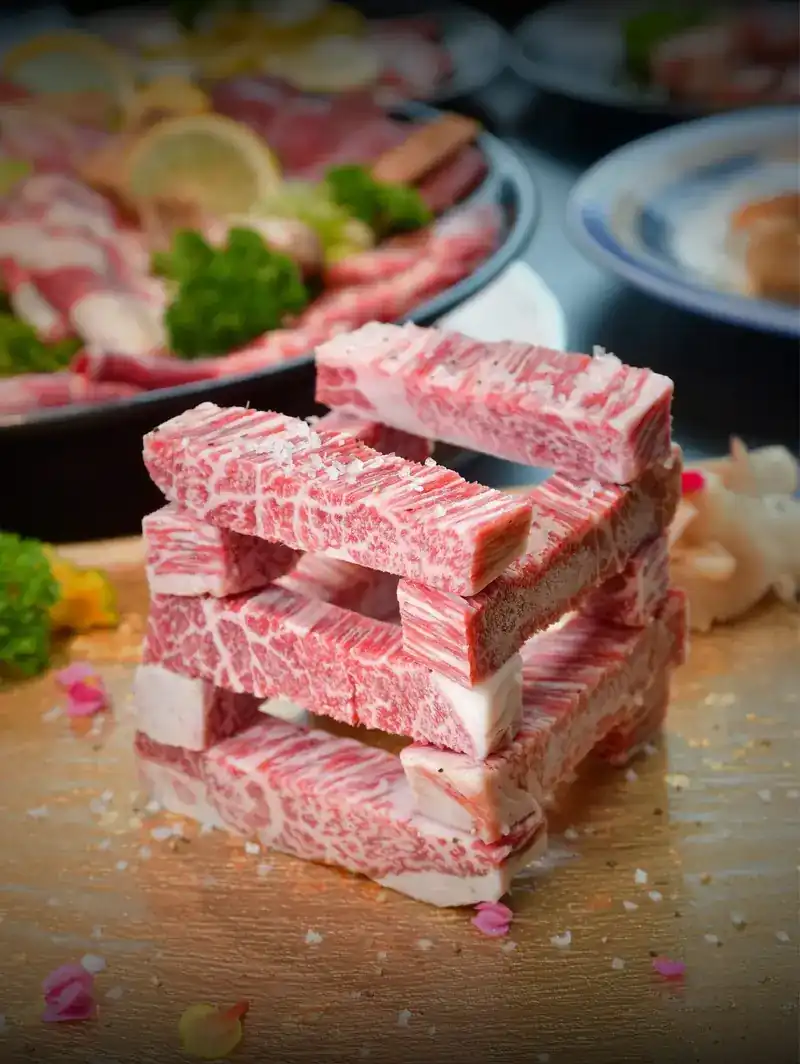 Bars of marbled beef stacked in a tower and sprinkled with salt