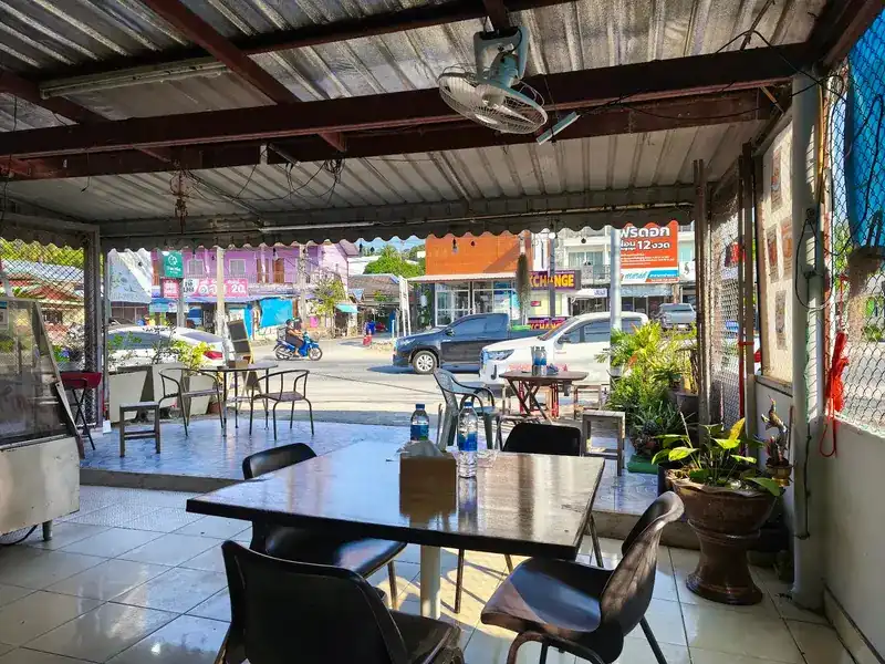Tables under the awning, open to the road