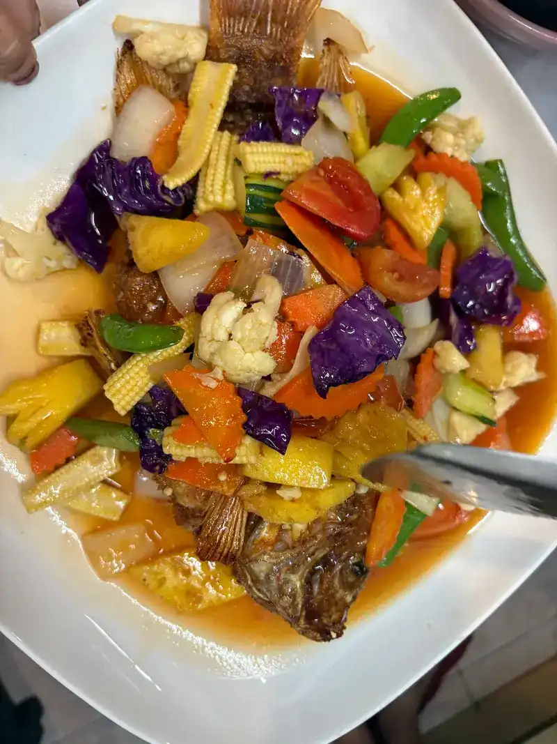 Fried fish under sweet-and-sour vegetables with pineapple and baby corn