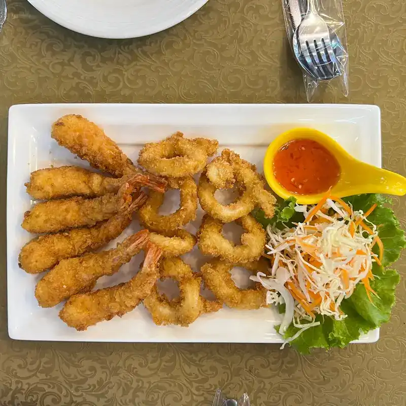 Fried prawns and squid rings with a sweet chilli dip and shredded salad
