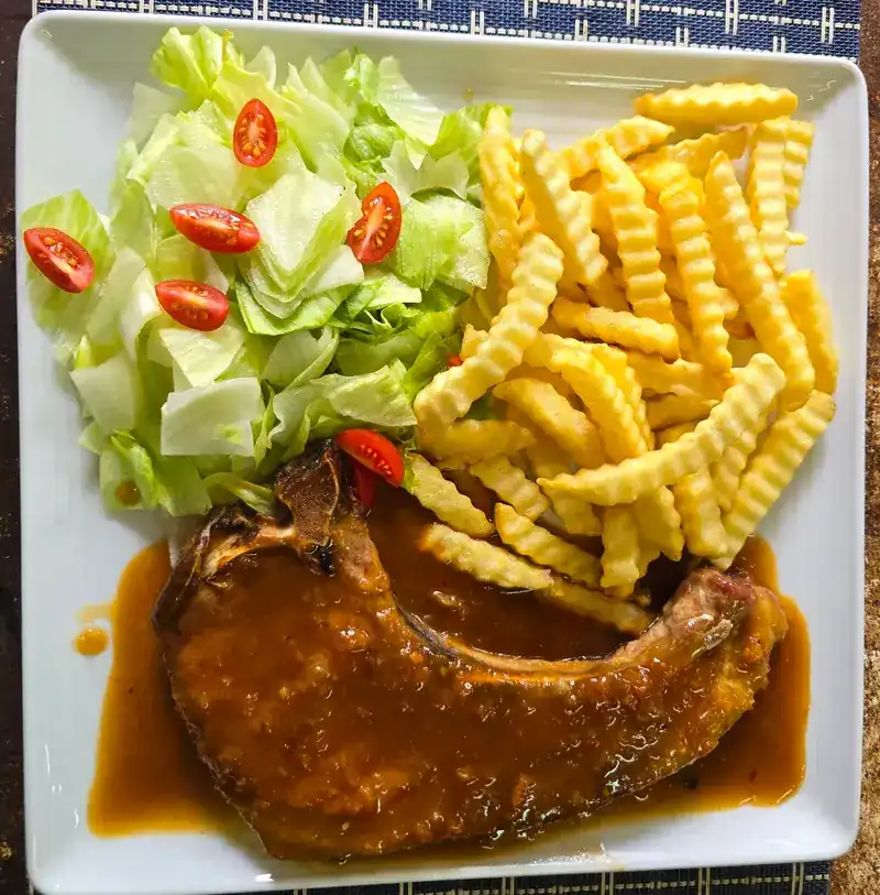 Pork chop steak with crinkle-cut fries and salad / สเต๊กพอร์คชอปกับเฟรนช์ฟรายส์และสลัด