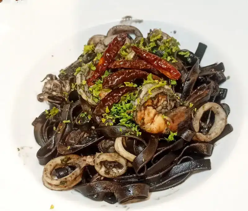 Black squid-ink pasta with squid, prawn and dried chillies