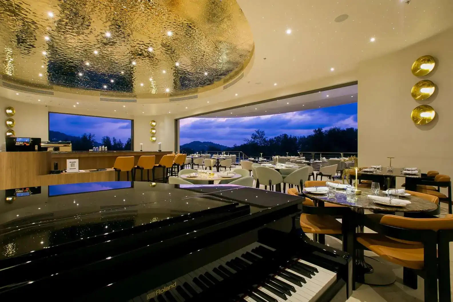 The dining room on the seventh floor: a hammered gold dome, a grand piano and wide windows onto the hills at dusk