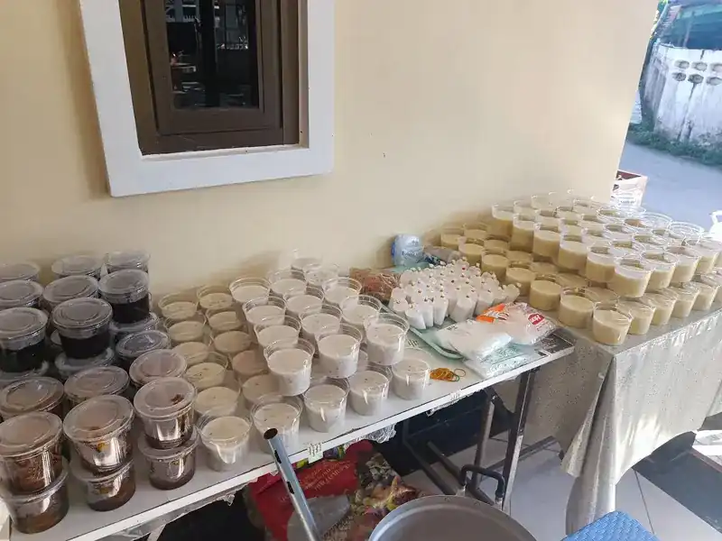 A long table of dessert cups and boxes under the front window