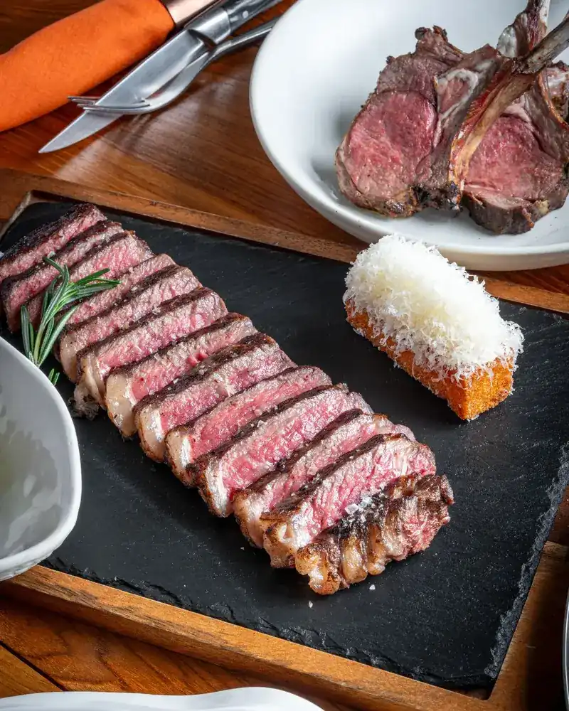 Sliced striploin on a slate board