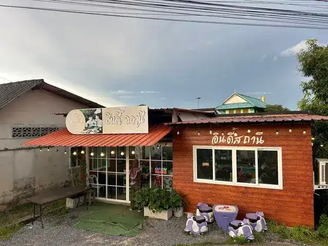 The wooden shop front of Indie Station with string lights