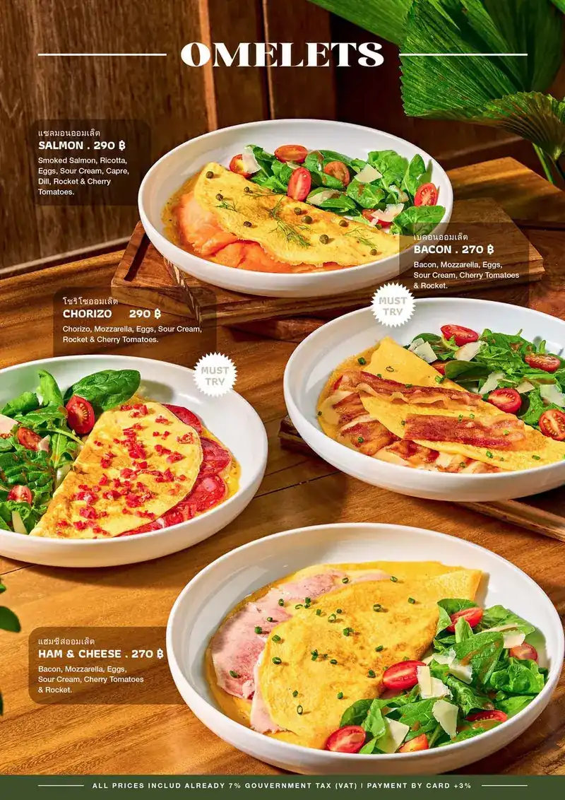 A folded omelette with ham beside a rocket and cherry tomato salad