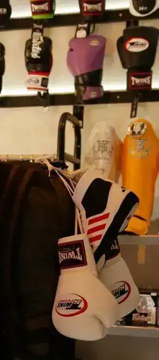 Boxing gloves hanging on the showroom wall and from a kit bag