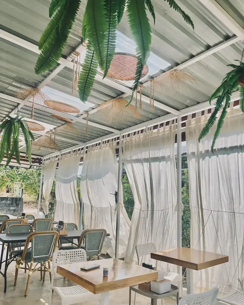 Tables beside the white curtains on the terrace
