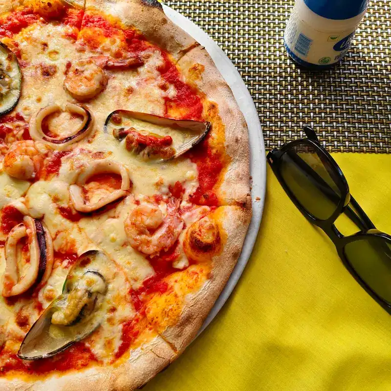Seafood pizza with squid, prawns and mussels