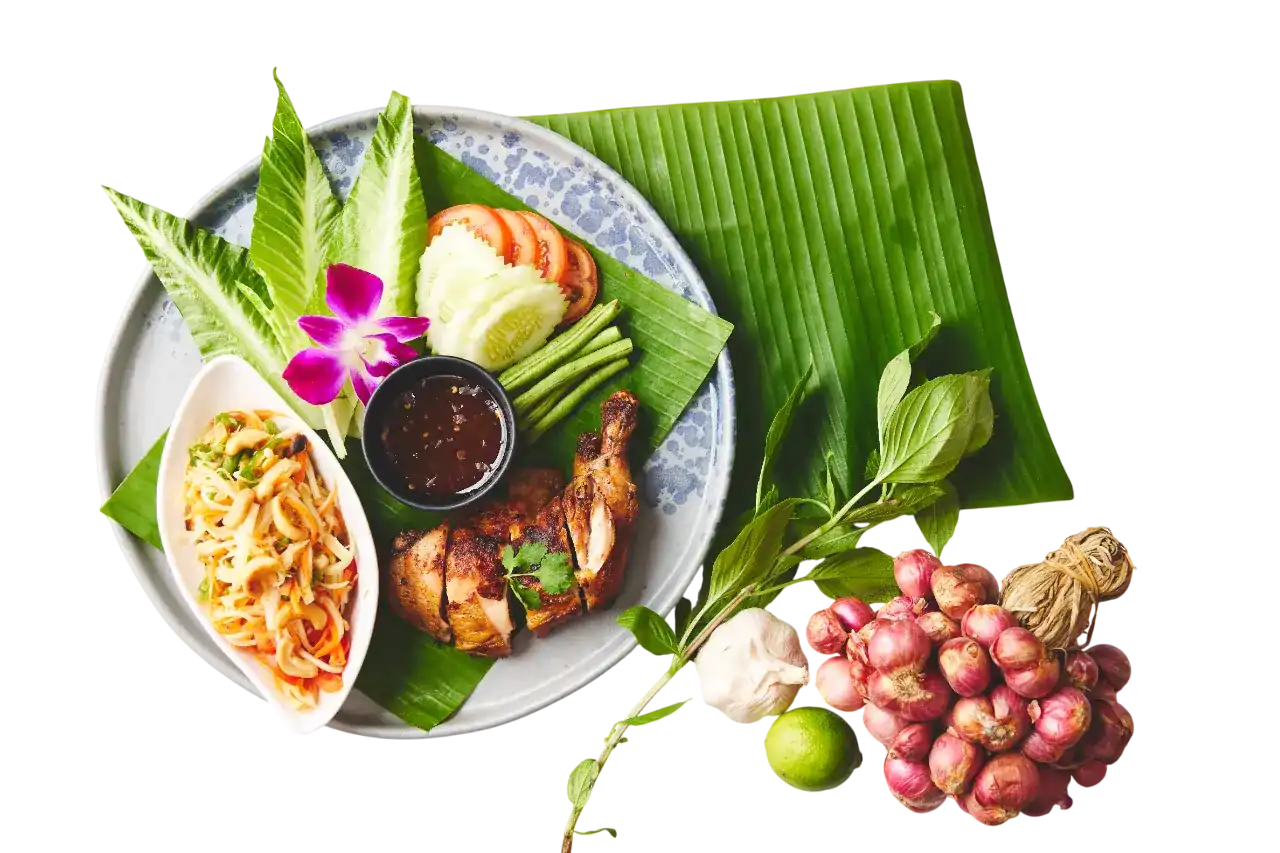 Som tum and grilled chicken with jaew dip on banana leaf