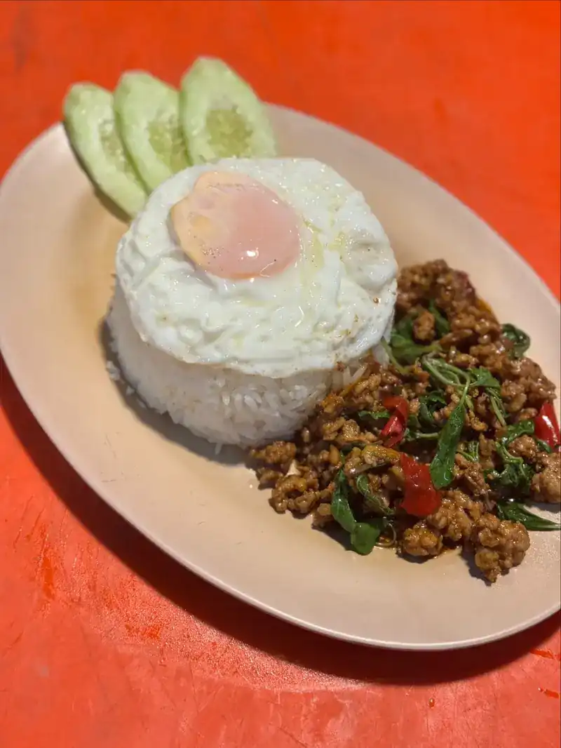 Stir-fried basil pork with rice, a fried egg and cucumber / ข้าวผัดกะเพราหมูไข่ดาว กับแตงกวา