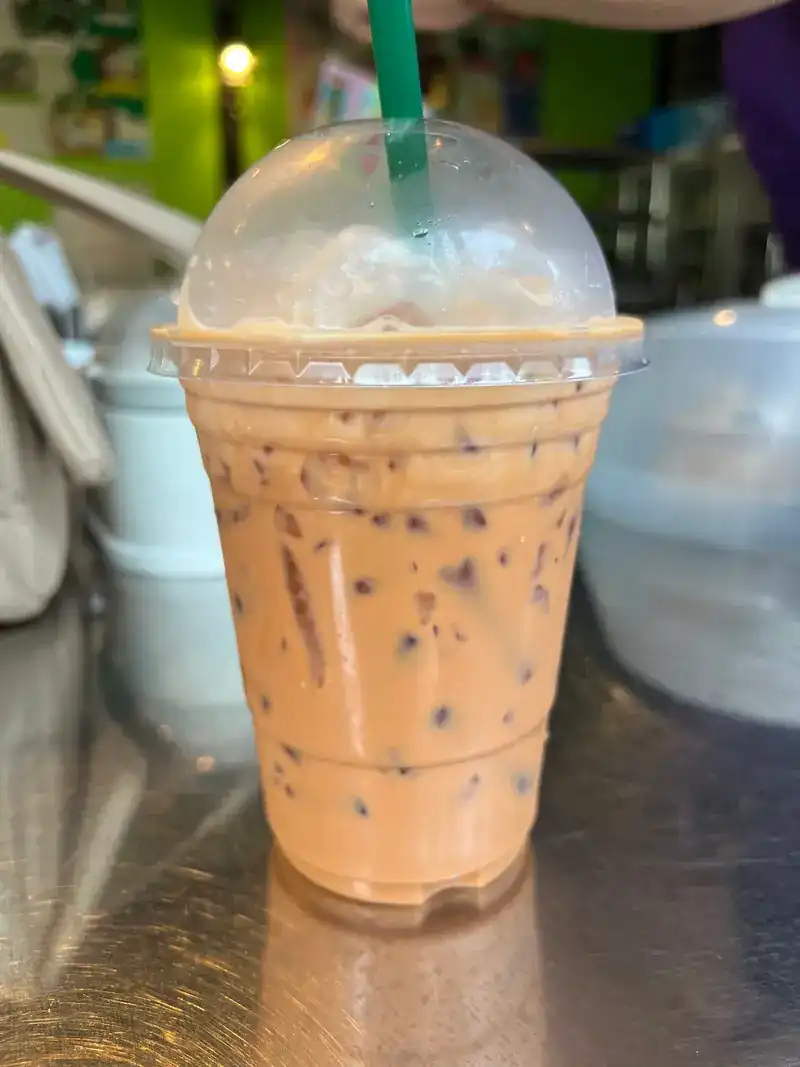 An iced milk drink in a takeaway cup